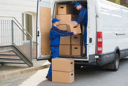 Removal team loading furniture safely from a Hampstead flat with narrow access