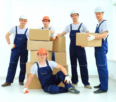 Removal team planning a flat move in Hampstead with boxes and furniture