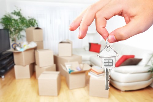Local movers handling office items in a Hampstead street with limited access