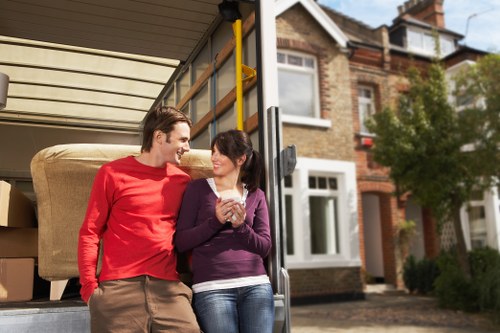 Professional movers handling boxes and furniture for a home relocation in Hampstead